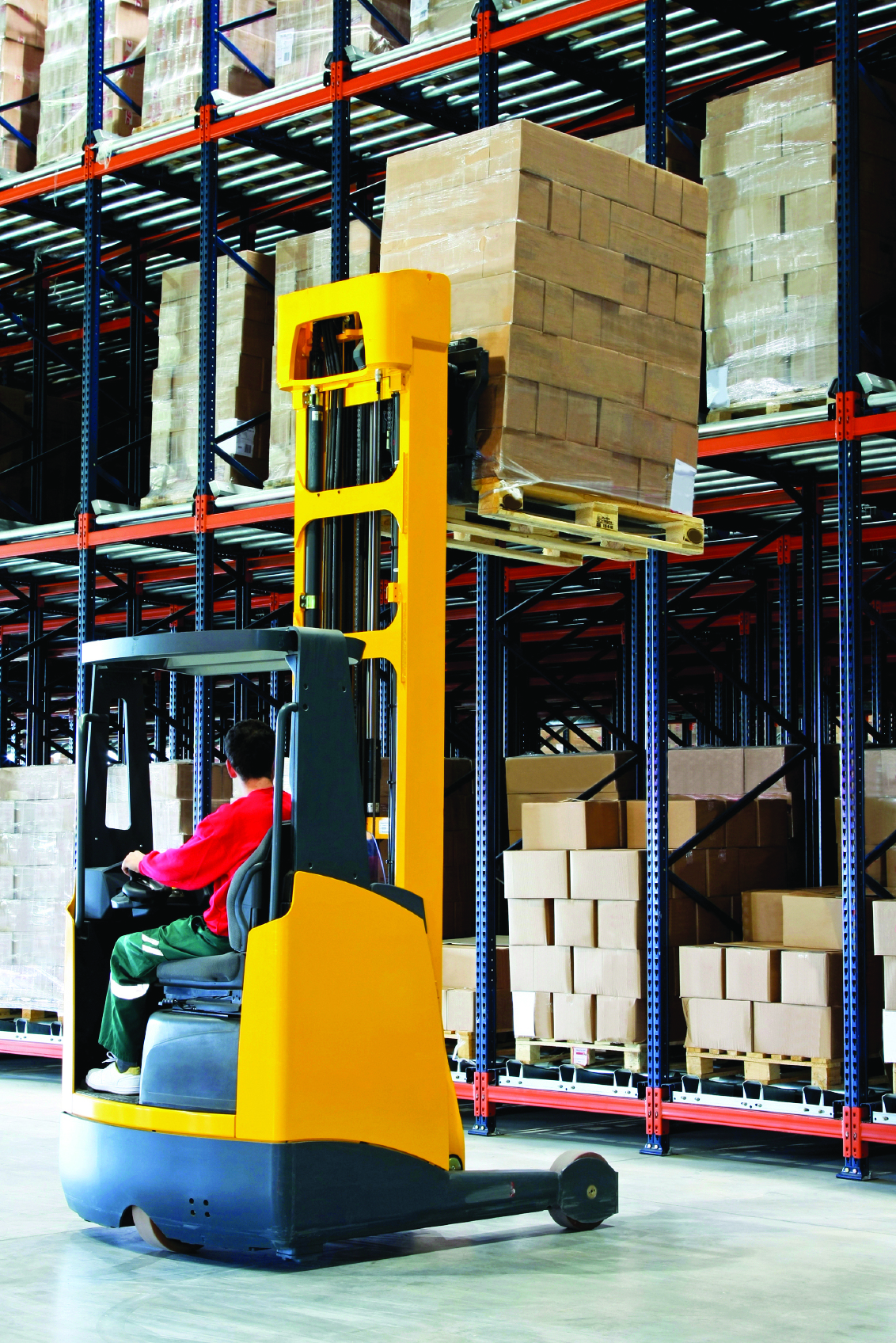 Yellow fork lifter with pallet in warehouse